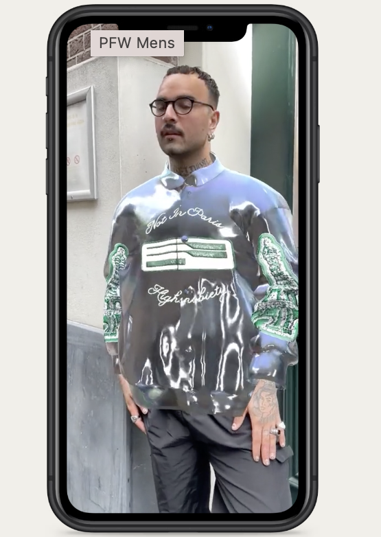 image of a man wearing a Varsity digital wearable jacket via AR on a smartphone