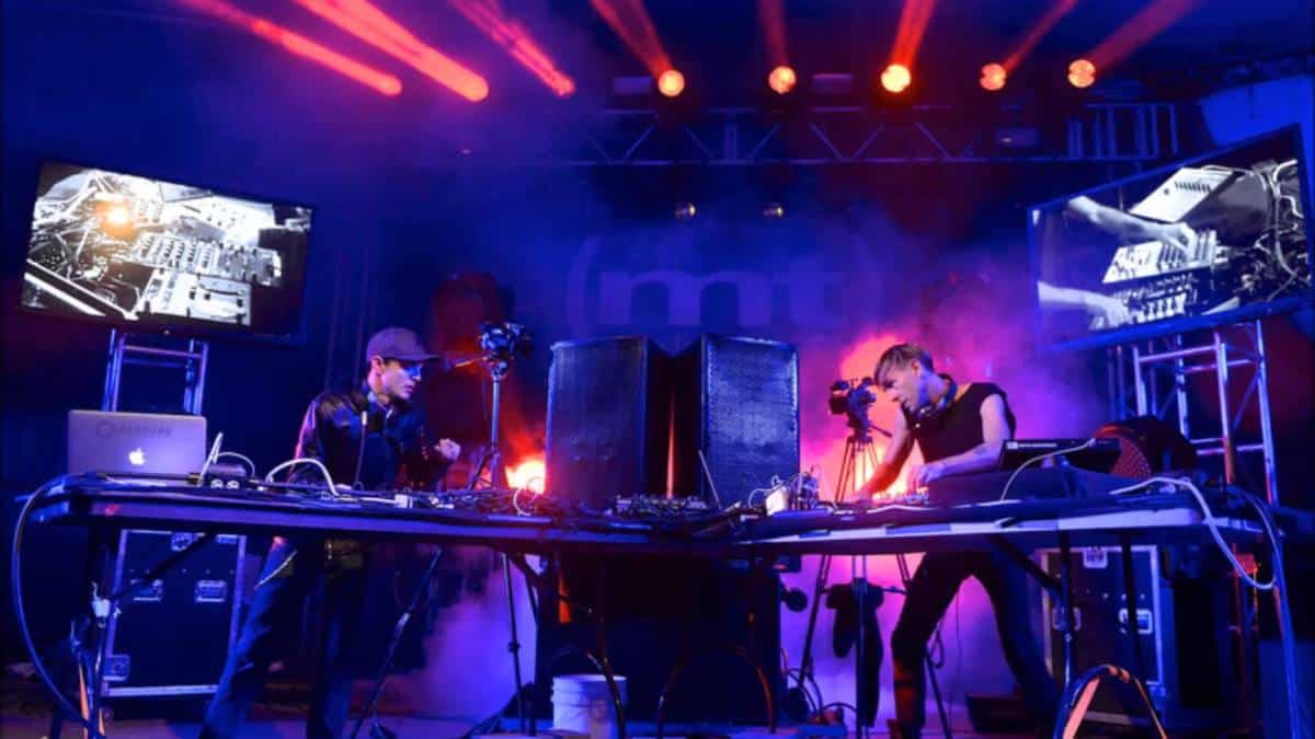 Deadmau5 and Richie Hawtin perform a set together on stage.